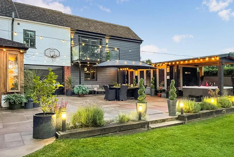 Myrtle Cottage rear property at dusk with festoon lights and garden