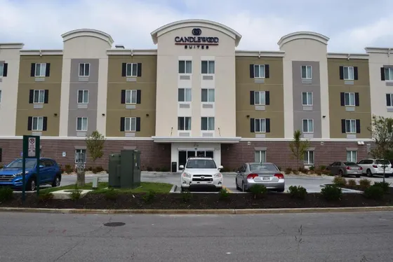 Large building with cars parked in a parking lot