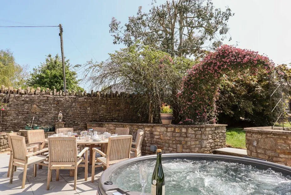 Nempnett Farmhouse hot tub in enclosed garden with outdoor dining and climbing roses