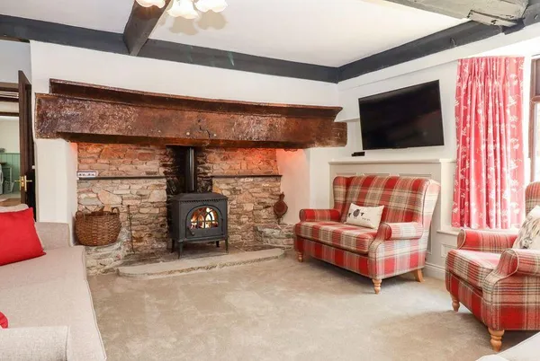 Nempnett Farmhouse living room with woodburning stove in stone fireplace