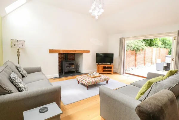 Oak Tree Lodge living room with wood burner and oak beam mantel