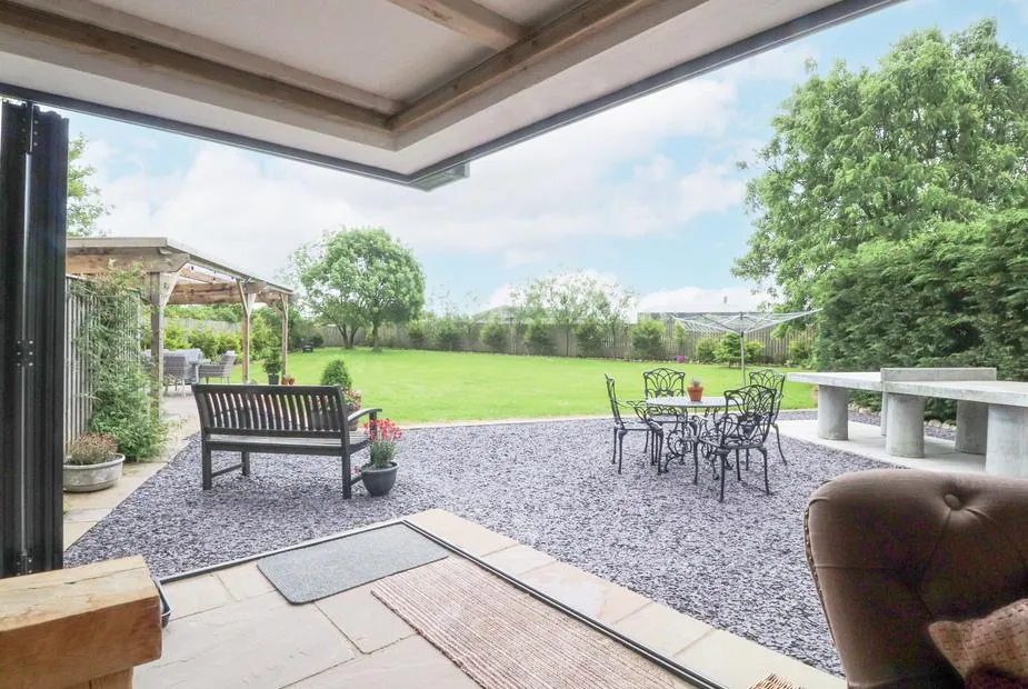 Old Bell Works living area with open doors to a lawn