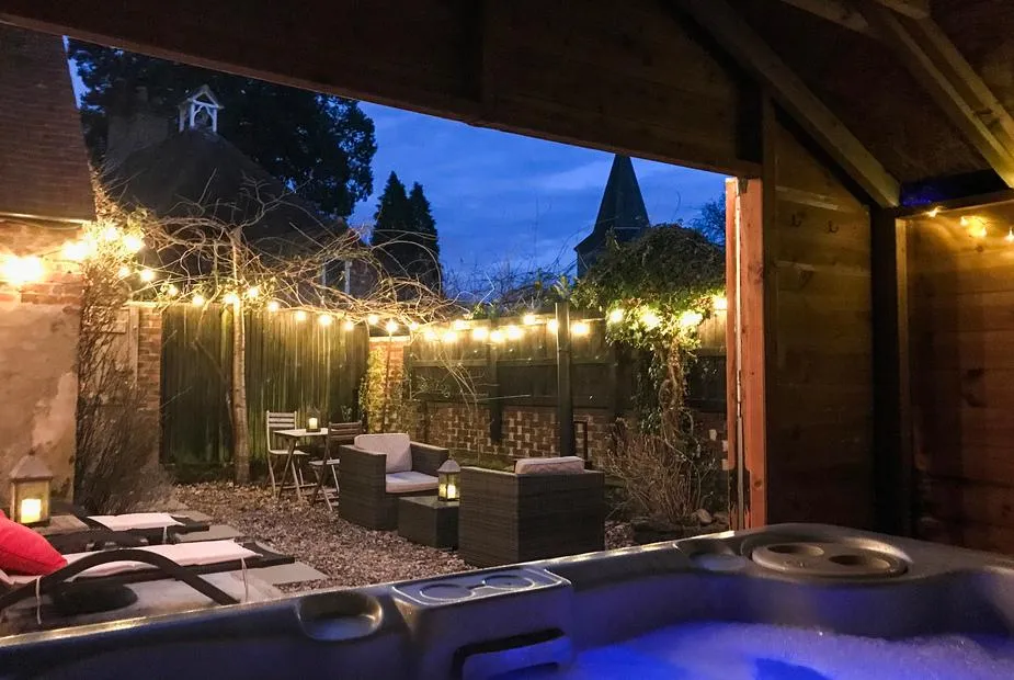 Old Rectory Cottage fairy-light hot tub glowing blue at dusk