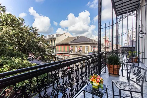 Iron balcony overlooking a street of historic buildings