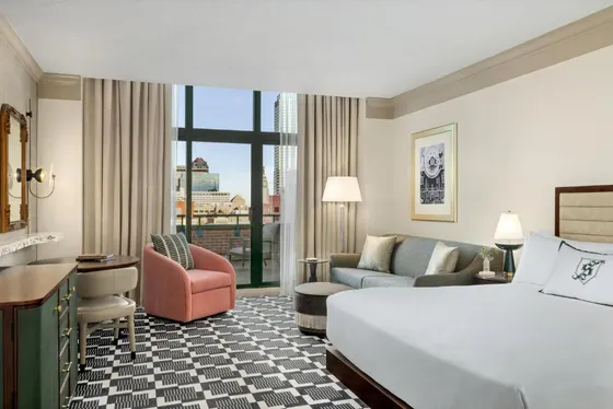 Guest room with a checkered carpet and city view