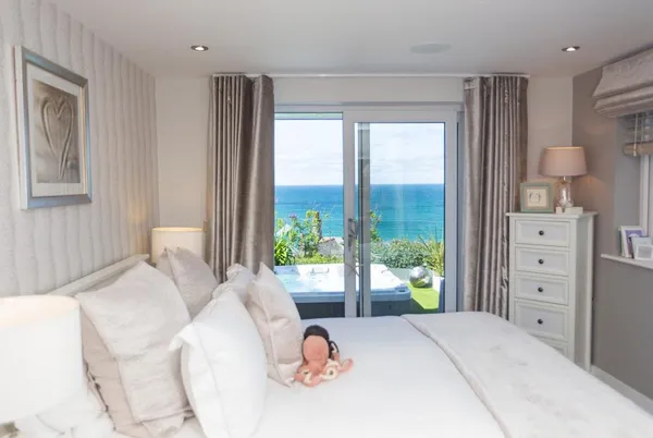 One Atlantic Watch bedroom with sea view and hot tub beyond the doors