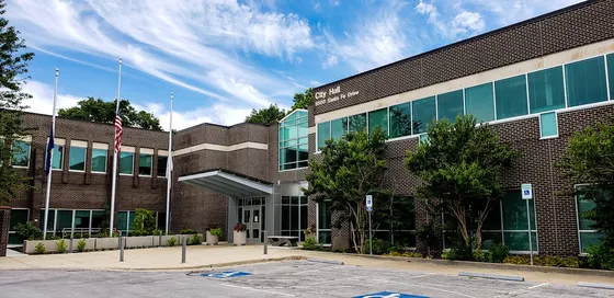 Overland Park City Hall and flagpoles beneath a blue sky