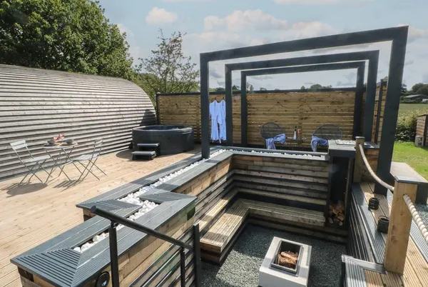 Paradise pod exterior with deck and sunken fire pit