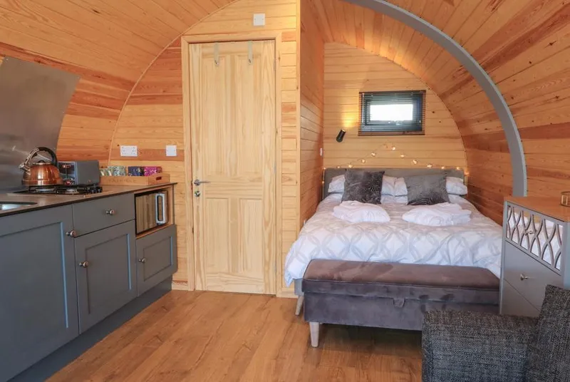 Paradise pod interior with bed and kitchenette