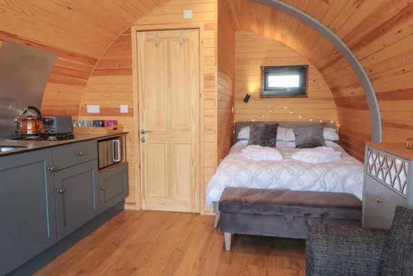 Paradise pod interior with bed and kitchenette