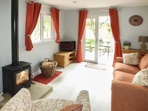Park Brook Retreat lounge with wood-burning stove and sofa