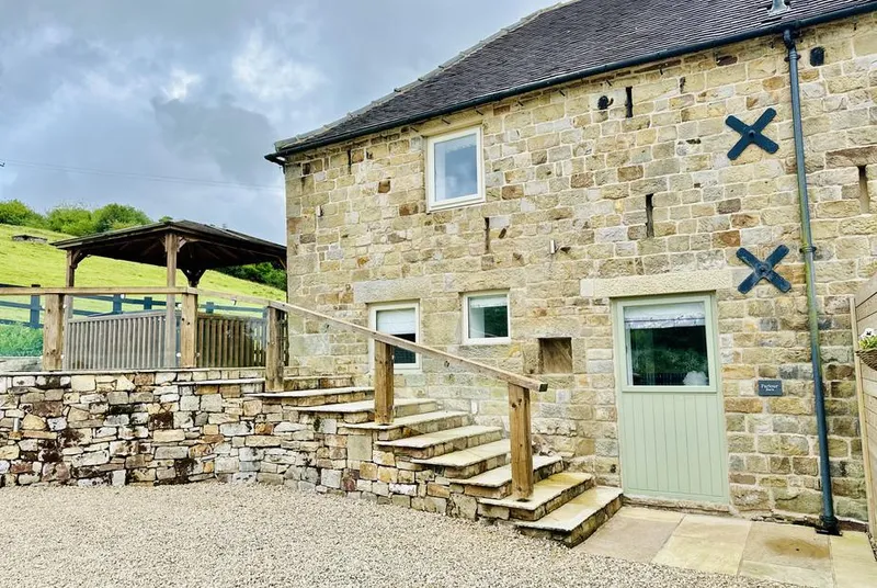 Parlour Barn ground-level stone facade with covered gazebo