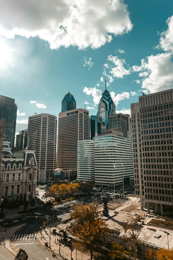 Philadelphia skyline under bright clouds on a sunny day