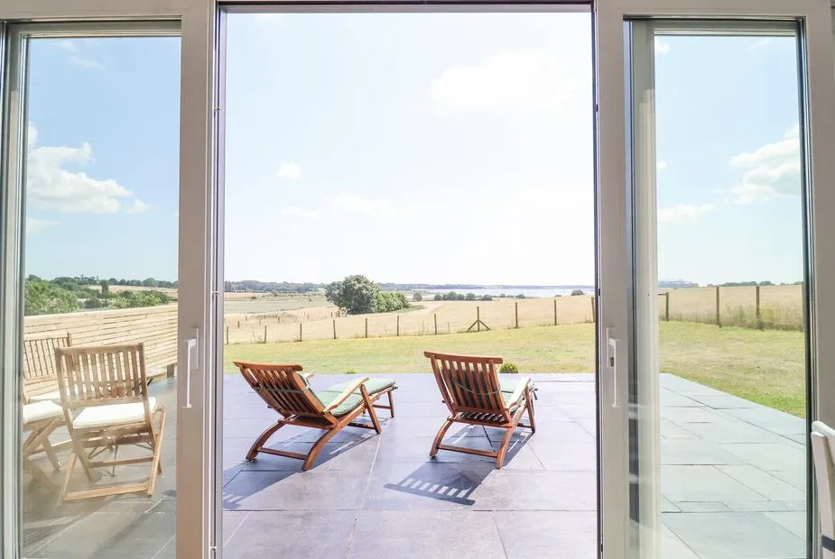 Polly's Annexe lounge with large windows and countryside views