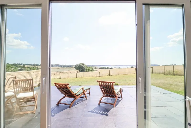 Polly's Annexe lounge with large windows and countryside views