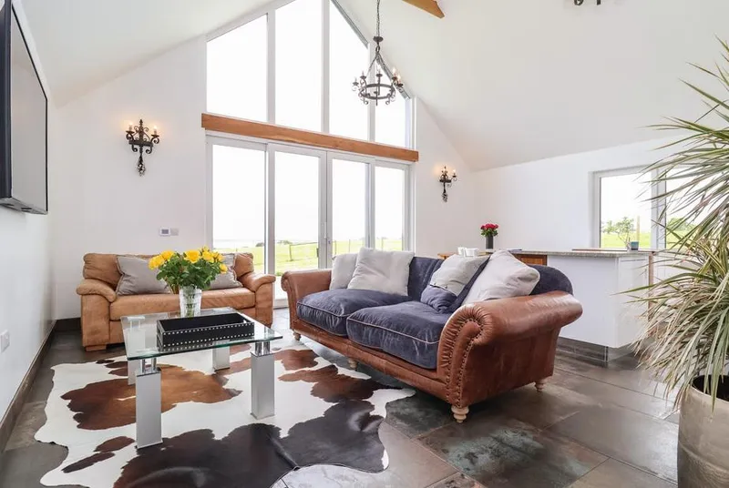 Polly's Annexe patio with loungers overlooking open countryside