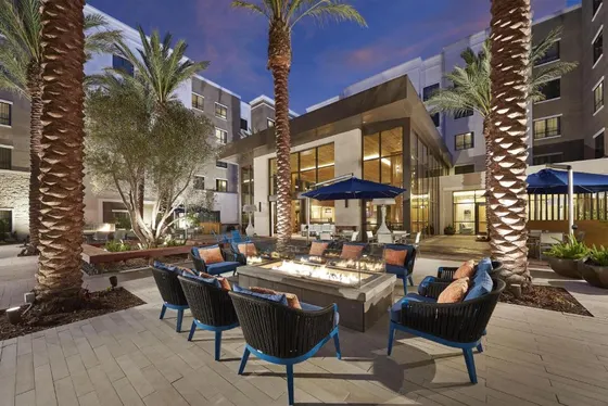 Patio with chairs and tables and palm trees