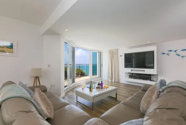 Portside lounge with open balcony doors and sea beyond