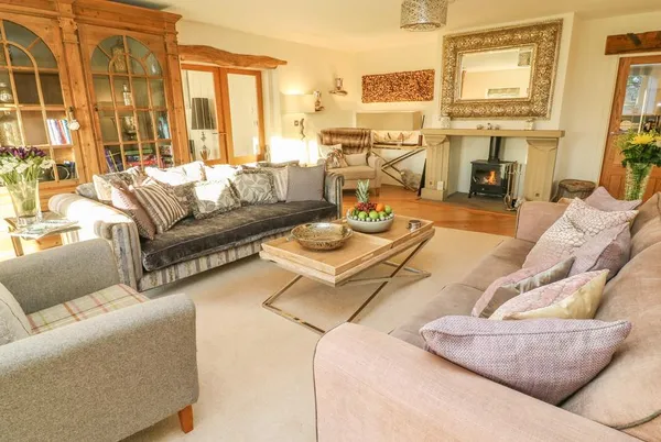 Flatt House Barn living room with wood burner and multiple sofas