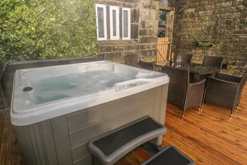 The Cottage, Beeston Hall hot tub on private deck by stone walls