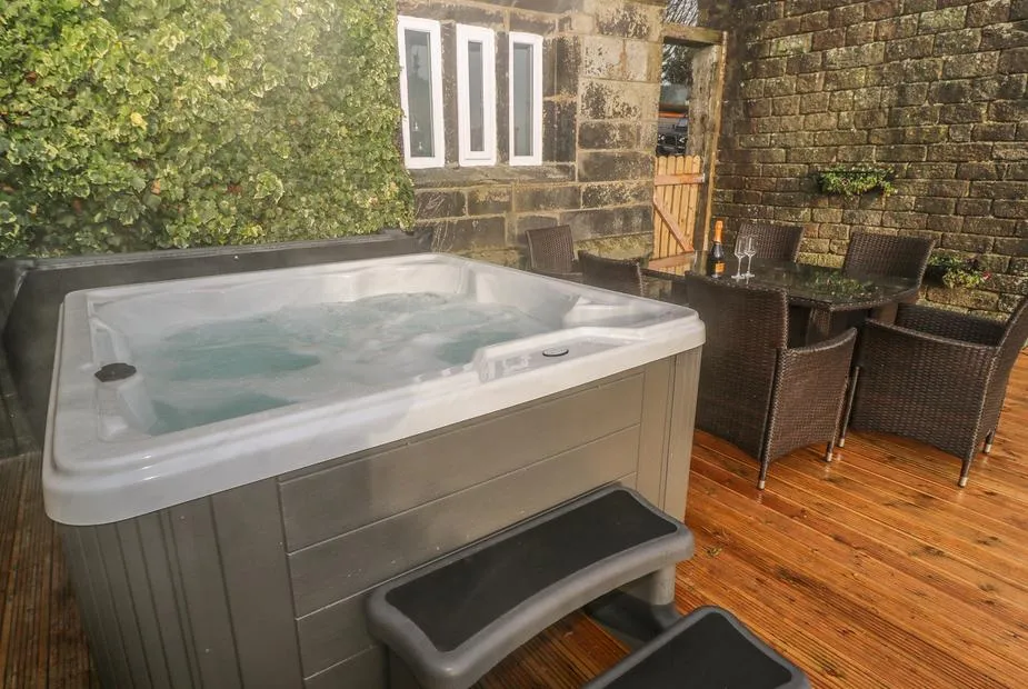 The Cottage, Beeston Hall hot tub on private deck by stone walls
