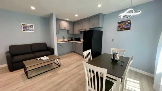 Kitchen and a living room with a table and a couch