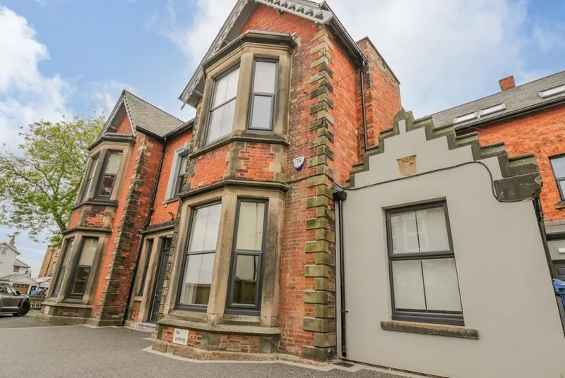 Railway House Victorian red brick facade with bay windows