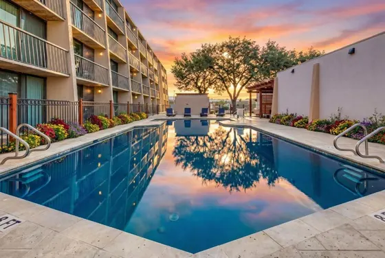 Rectangular pool reflecting an orange sunset sky