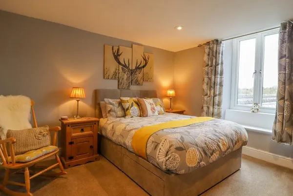 Ramblers Retreat master bedroom with stag art and warm lighting