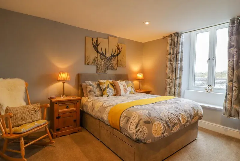 Ramblers Retreat master bedroom with stag art and warm lighting