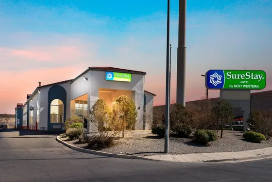 White hotel at sunset with a SureStay by Best Western sign