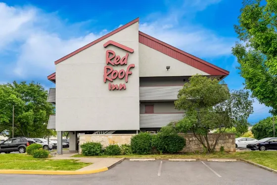 Building with a red roof with a sign on it