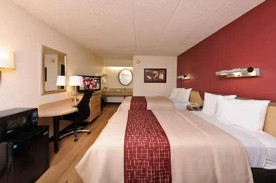 Hotel room with two beds and a desk