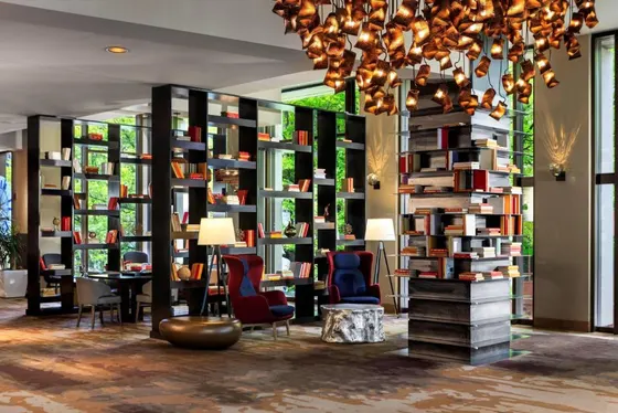 Library with shelves of books and chairs and a chandelier