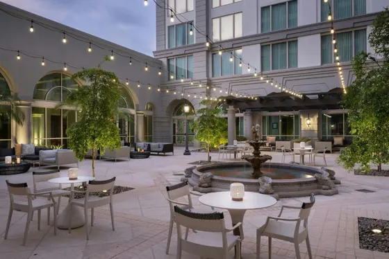 Courtyard with tables and chairs in front of a building
