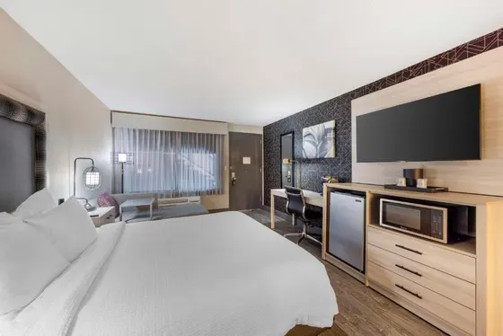 Hotel room with a bed and a flat screen tv