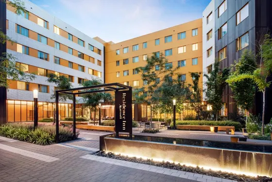 Hotel courtyard with a sign in front of a building