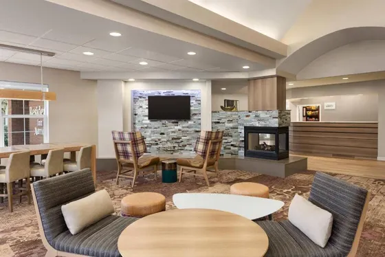 Lobby with a fireplace and a table and chairs