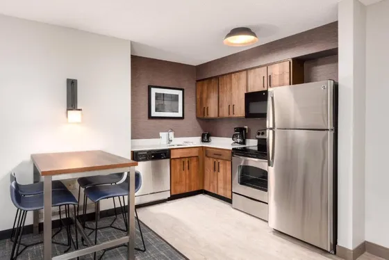 Kitchen with wooden cabinets and a stainless steel refrigerator