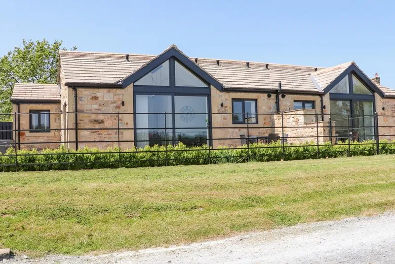 Ribble View stone lodge frontage with a large glazed gable