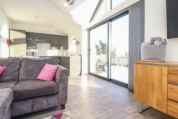 Ribble View living room with a glazed wall and sofa