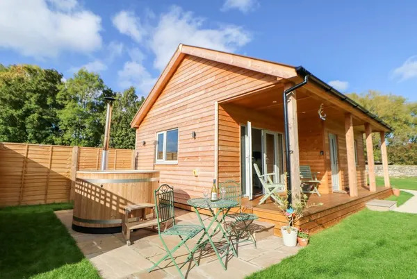 Rising Sun lodge front with wooden hot tub visible