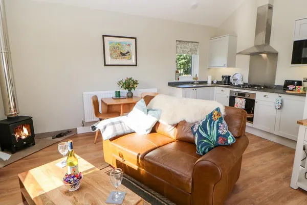 Rising Sun open-plan living with wood burner and leather sofa