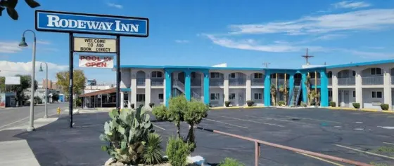 Blue Rodeway Inn sign in front of a two-story motel