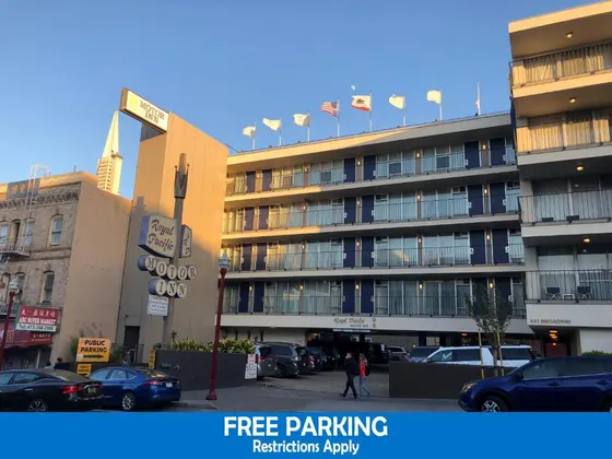 Large building with cars parked in a parking lot
