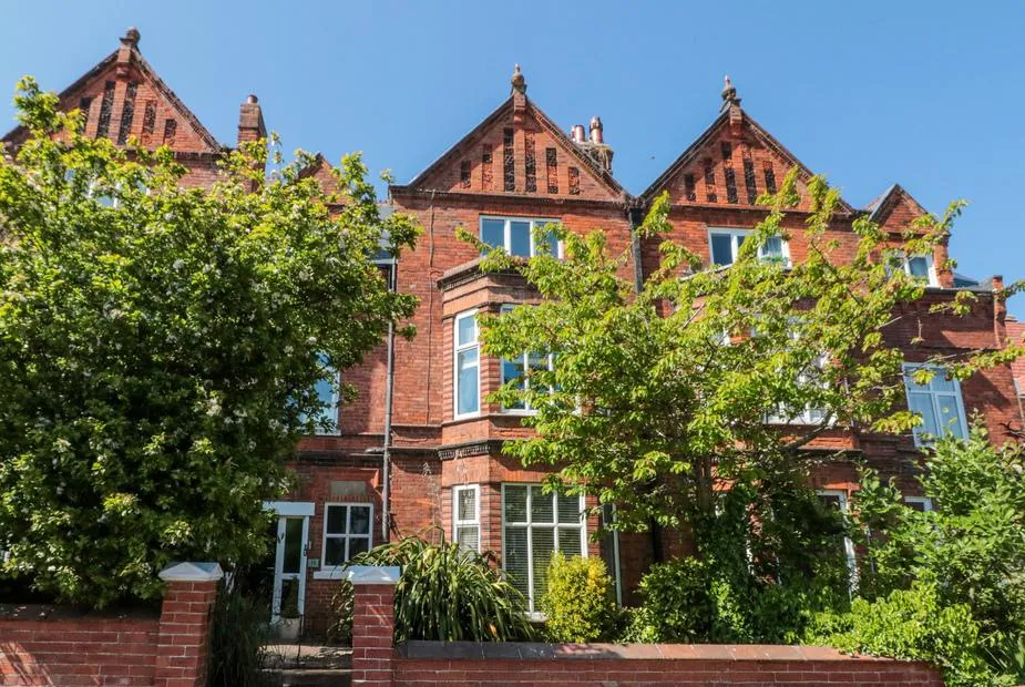 Royal Victoria House Victorian red brick facade under blue sky