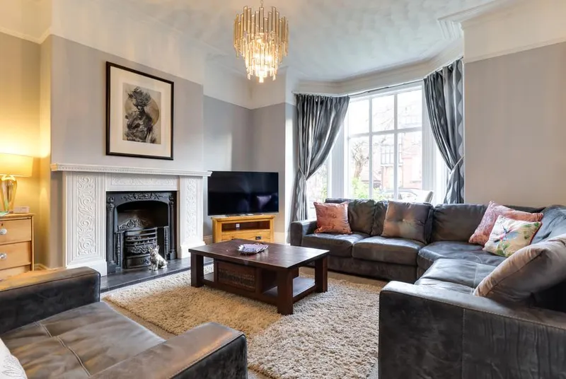 Royal Victoria House living room with ornate Victorian fireplace and bay window