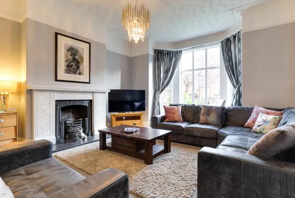 Royal Victoria House living room with ornate Victorian fireplace and bay window