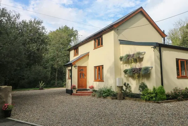 Rudbaxton Water cream house exterior by the gravel drive