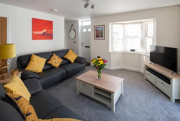 Salt Bay living room with bay window and leather sofas